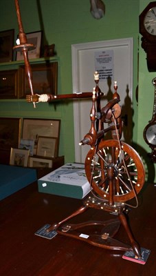 Lot 1779 - A 19th century fruitwood spinning wheel with turned ivory fitments