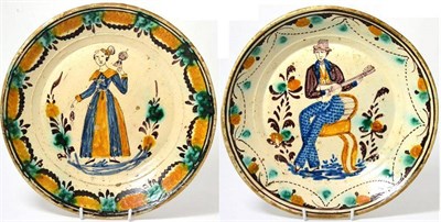 Lot 8 - A central European faience circular dish, early 19th century, painted in colours with a seated...