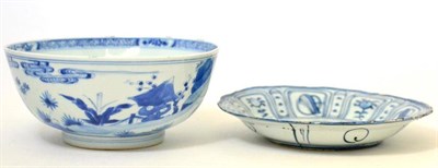 Lot 9 - A Chinese porcelain bowl painted in underglaze blue with figures in buildings and gardens,...