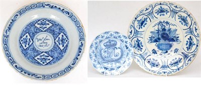 Lot 19 - A Delft plate, mid-18th century, painted in blue with crowned initials within a lattice border,...