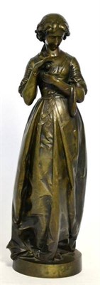Lot 26 - A French bronze figure of a girl, circa 1900, standing wearing flowing robes holding a fruit on...