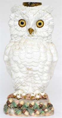 Lot 27 - A German porcelain lamp base, circa 1900, in the form of a owl with glass eyes perched on a...