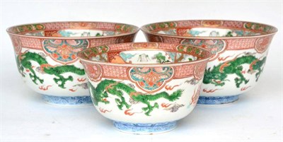 Lot 28 - A graduated set of three Imari porcelain bowls painted in colours with panels of landscape,...