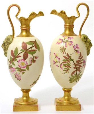 Lot 33 - A matched pair of Royal Worcester porcelain ewers, 1888, painted with wild flowers on an ivory...