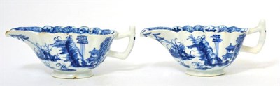Lot 37 - A pair of Bow porcelain fluted sauce boats, circa 1765, painted in an underglaze blue with the...