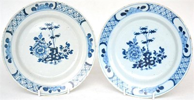 Lot 44 - A pair of English Delft plates, circa 1750, painted in blue with peony, bamboo and rockwork...