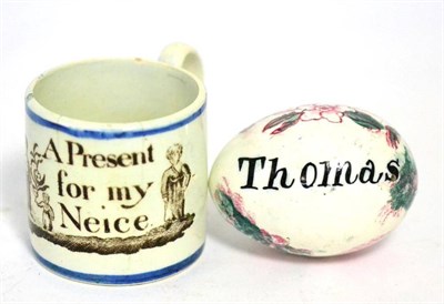 Lot 62 - A Pearlware darning egg, early 19th century, painted with a bull and inscribed ";Thomas";, 6cm...