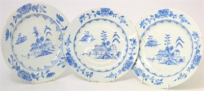 Lot 83 - A set of three Bow porcelain plates, circa 1765, painted with an underglaze blue with...