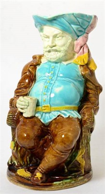 Lot 85 - A Staffordshire majolica character jug, circa 1880, modelled as Falstaff, sitting drinking from...