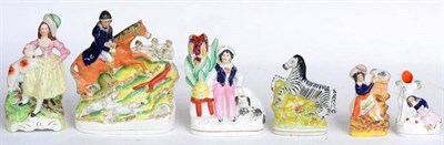 Lot 95 - A Staffordshire pottery figure group of a foxhunt, 24cm high; a spill vase with a boy sitting...