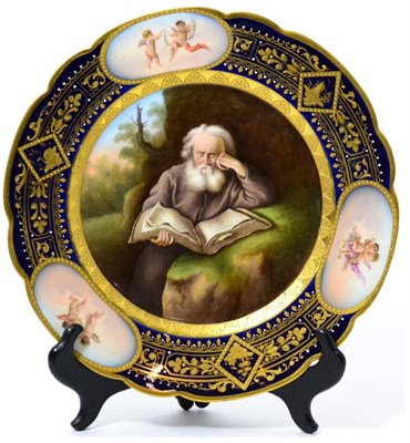 Lot 105 - A Vienna style porcelain cabinet plate, circa 1900, painted with a hermit reading from the...