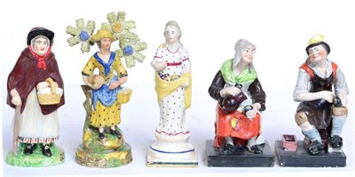 Lot 108 - A Walton type pearlware figure of a girl standing before bocage holding a barrel and basket,...