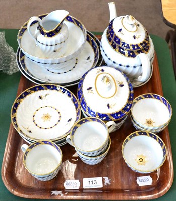 Lot 113 - A Worcester porcelain tea service, circa 1790, of writhen fluted form painted in underglaze...