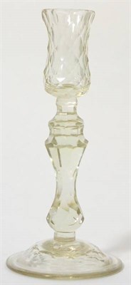 Lot 145 - A glass candlestick, circa 1780 with facetted socket and baluster stem, 23cm high