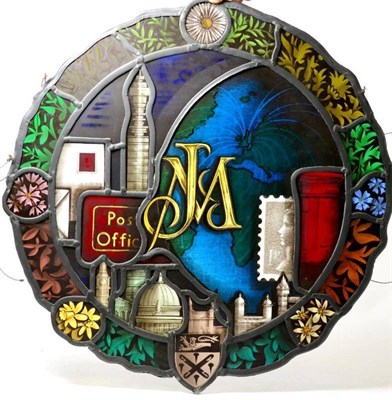 Lot 149 - A leaded stained glass roundel centred by a monogram decorated with the post office tower, post...