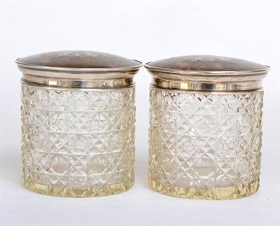 Lot 154 - ^ A pair of George V silver and tortoiseshell mounted cut glass dressing table jars, Birmingham...