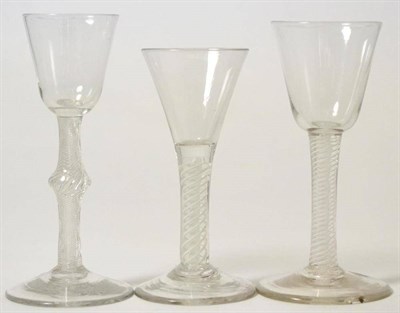 Lot 166 - A wine glass, circa 1750, the rounded funnel bowl on a knopped air twist stem, 16cm high; a similar