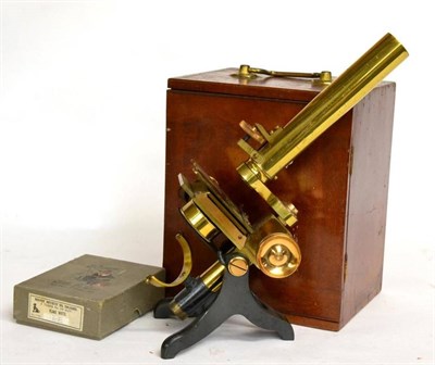 Lot 185 - A Negretti & Zambra brass monocular microscope, late 19th century, in fitted mahogany case with...