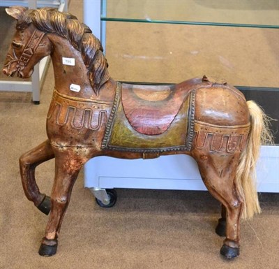 Lot 195 - A carved and painted wooden horse, naturalistically modelled with a saddle, 82cm high