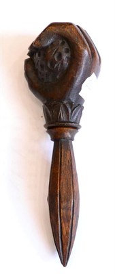 Lot 201 - A treen nut cracker, 19th century, as a hand holding a nut, 18cm