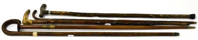 Lot 203 - A turned wood sword stick, circa 1900, with brass ferrule and disk pommel, 91cm; and four...