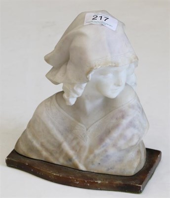 Lot 217 - ^ A carved alabaster bust of young girl, French, early 20th century, wearing a lace trimmed cap and