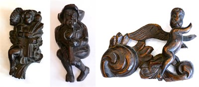 Lot 220 - A carved oak figure of a musician, 16th century, playing a serpent, 18cm; a carved oak figure...