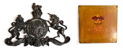 Lot 228 - A cast iron plaque, with the arms of Queen Victoria, 29cm wide; and a small coach panel,...