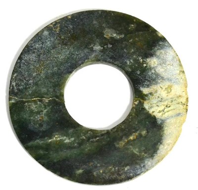 Lot 234 - A Chinese jade bi-disk of plain circular form, 14cm diameter