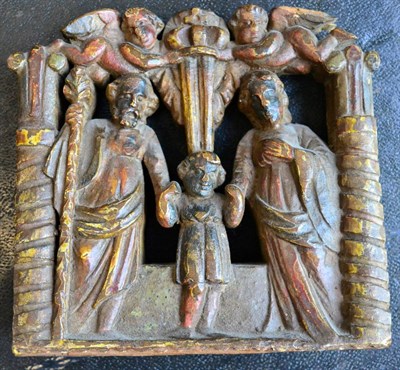 Lot 238 - A Dutch elm carriage panel, circa 1700, carved with the Holy Family below two angels holding a...