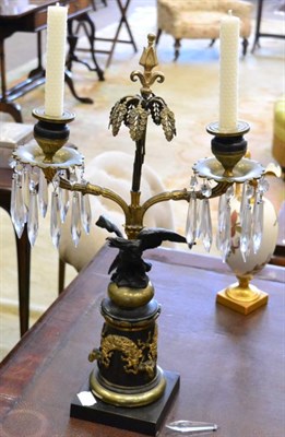 Lot 243 - A gilt and patinated bronze twin branch candelabrum in French Empire style, with foliate...