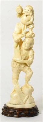 Lot 250 - A Japanese ivory okimono, Meiji period, as a man holding scrolls and a figure on a cloud scroll...