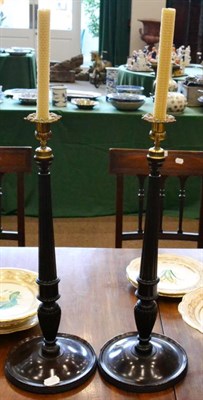 Lot 282 - A pair of turned mahogany candlesticks, early 19th century,with brass foliate sconces, fluted...