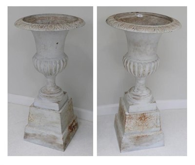 Lot 283 - A pair of white painted cast iron campana urns, 19th century, with egg and dart rims, on square...