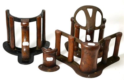 Lot 293 - A set of four various Musgrave patent cast iron and mahogany harness racks, late 19th century