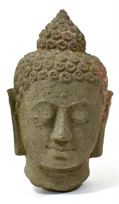 Lot 298 - A Southeast Asian carved stone head of a Buddha, with some pigment, 38cm high