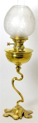 Lot 305 - A Victorian brass oil lamp with etched glass shade and glass chimney, semi ovoid reservoir on a...