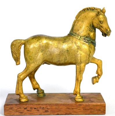 Lot 318 - After the Antique, a gilt bronze figure of a pacing horse on a wooden base, 18cm long