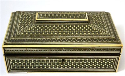 Lot 319 - An Anglo-Indian ivory and ebony dressing table box, 19th century, of sarcophagus form, the interior