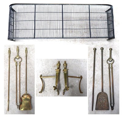 Lot 411 - A three piece brass companion set, irons and a brass spark guard