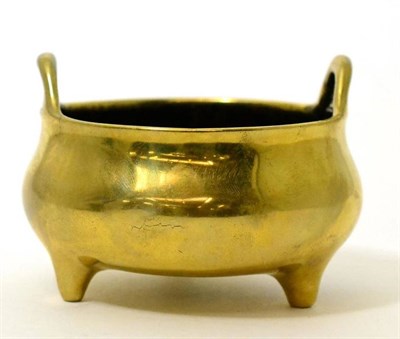 Lot 415 - A bronze ding of ovoid form with twin handles and three feet, bears six character Xuande reign...