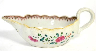 Lot 417 - A Chinese armorial porcelain sauce boat, circa 1770, of fluted oval form painted with the arms...