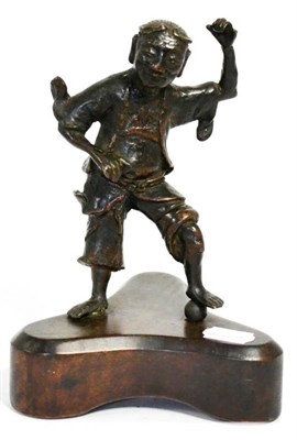 Lot 418 - A Chinese bronze figure of Li Tieguai, his foot on a ball, 18.5cm high, on later wooden stand