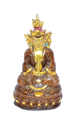 Lot 419 - A Chinese bronze figure of Buddha, sitting cross legged on lotus throne, 11.5cm high