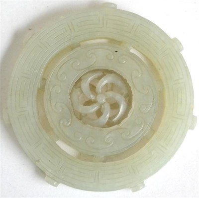 Lot 426 - A Chinese jade plaque carved with an articulated spiral within two concentric circular bands,...