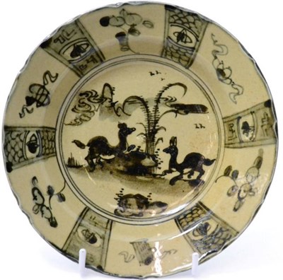 Lot 433 - A Chinese porcelain dish painted in Kraak style with panels of animals and objects, bears...