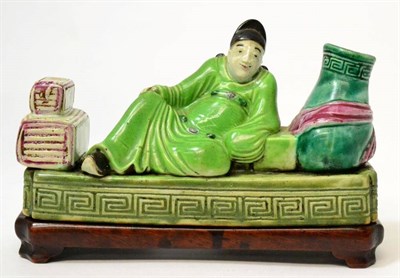 Lot 434 - A Chinese porcelain figure of a scholar, 19th century, sitting on a dais flanked by a vase and...