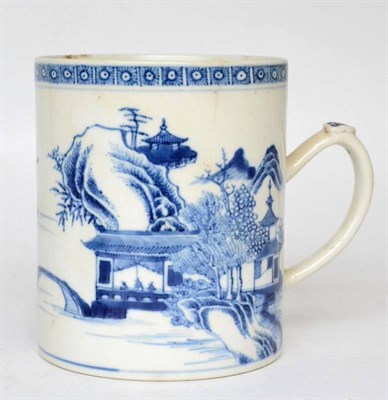 Lot 439 - A Chinese porcelain mug, Qianlong, painted in underglaze blue with buildings in a river...