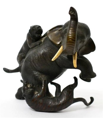 Lot 447 - A Japanese bronze elephant group, Meiji period, the elephant with bone tusks being attacked by...