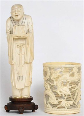 Lot 449 - A Japanese ivory figure and attendant, Meiji period, standing wearing flowing robes and holding...